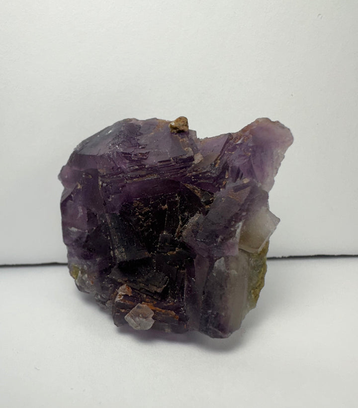 Purple cubic fluorite crystal specimen on matrix with dark internal sections