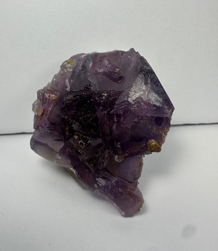 Purple fluorite crystal cluster on matrix, angular faces and dark crystal growth