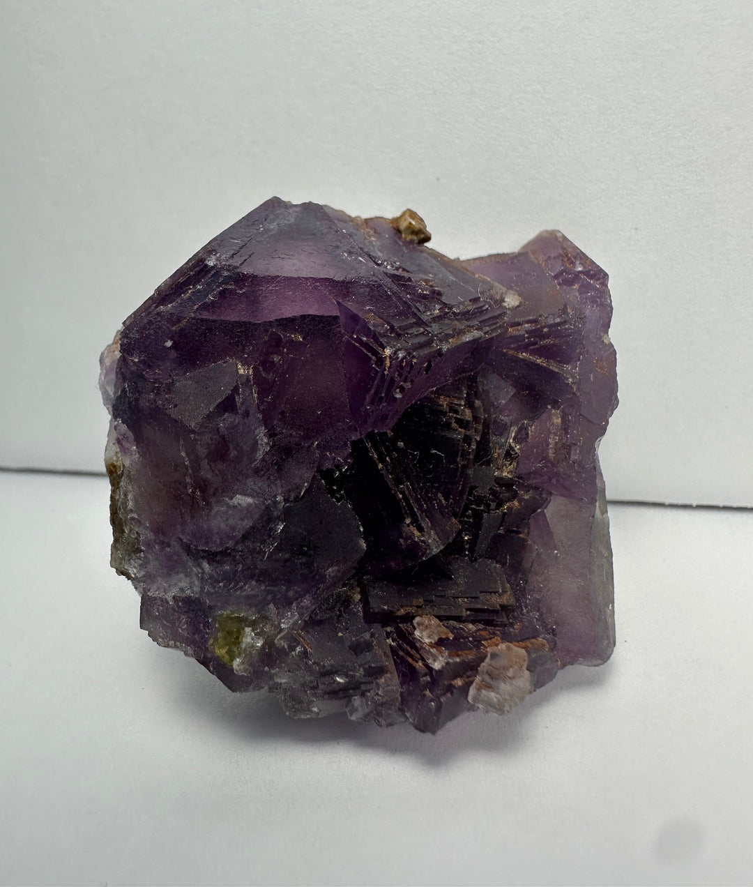 Purple fluorite crystal cluster on matrix, glossy facets with tan inclusions