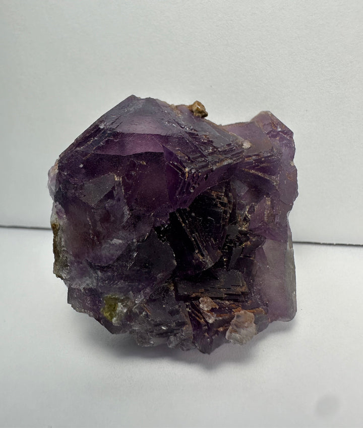 Purple fluorite crystal cluster on matrix, glossy facets with tan inclusions