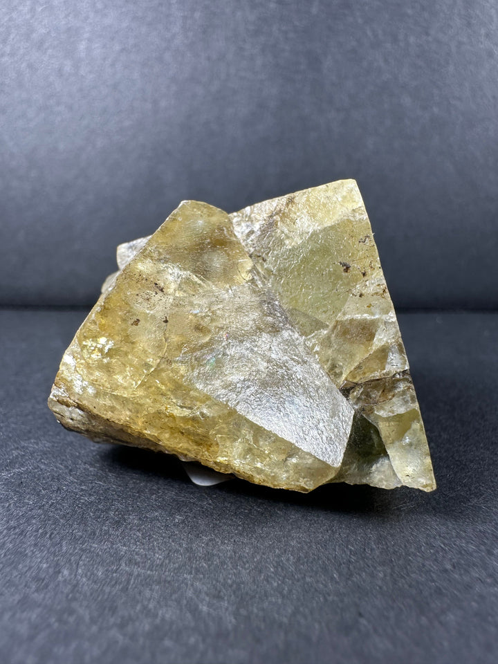 Yellow fluorite crystal cluster with faceted translucent yellow and clear crystal faces