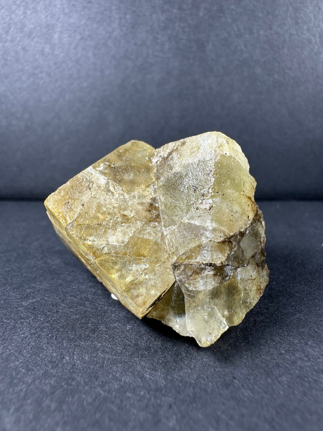 Yellow fluorite crystal cluster with rough faceted surfaces and clear highlights