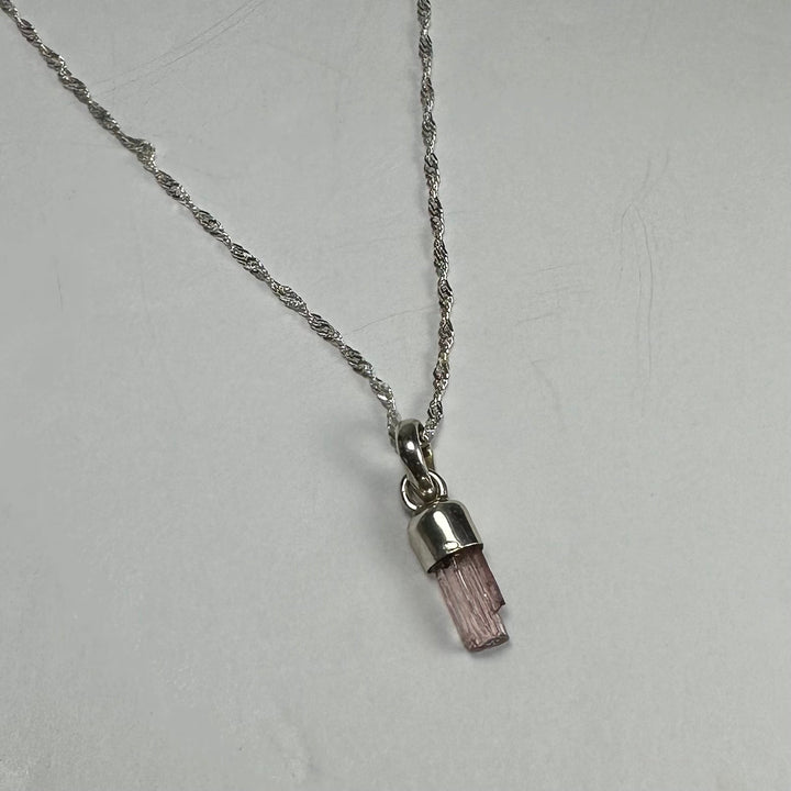 Pink tourmaline pencil pendant on silver-toned link chain
