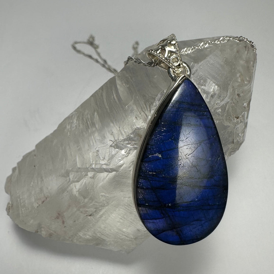 Teardrop blue labradorite pendant with silver-tone bail on necklace chain