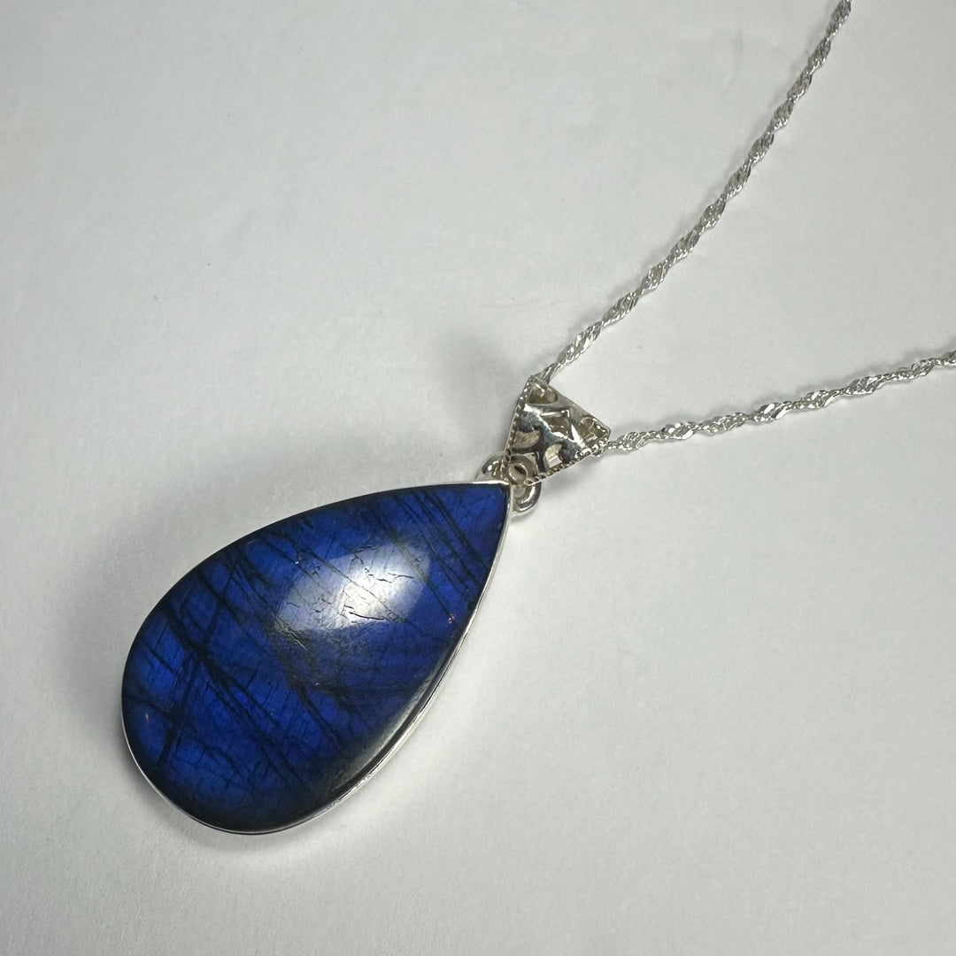Blue labradorite teardrop pendant with silver-tone bail and chain