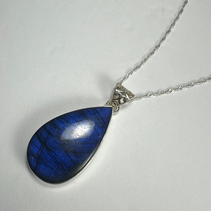 Blue labradorite teardrop pendant with silver-tone bail and chain
