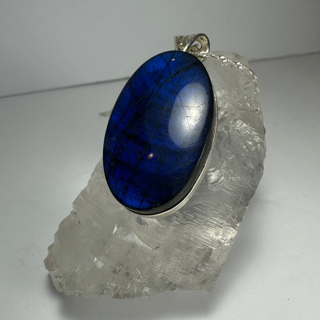 Blue labradorite oval pendant with silver-tone bail on chain