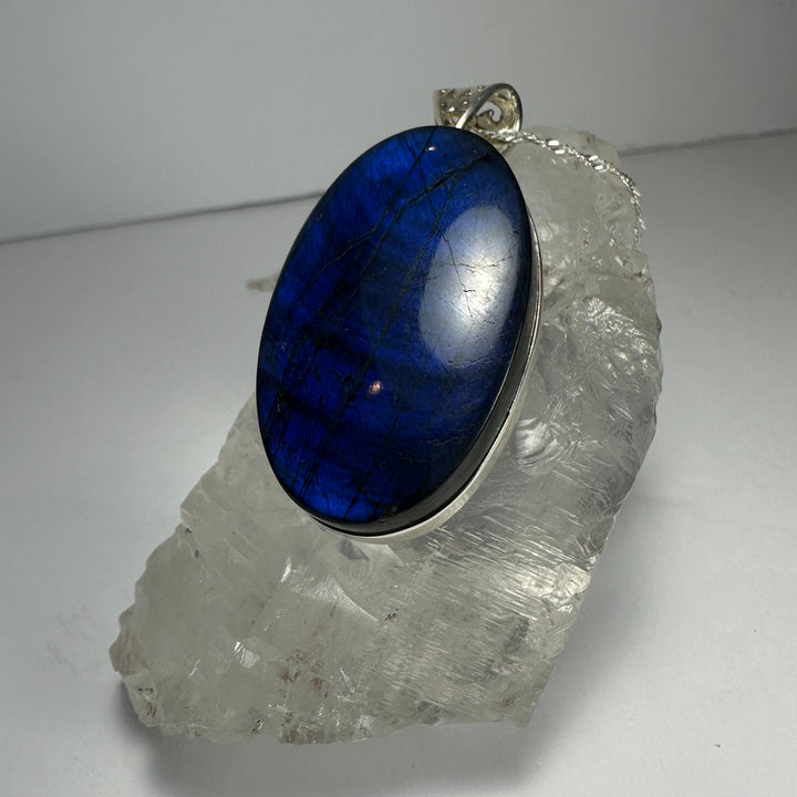 Blue labradorite oval pendant with silver-tone bail on chain