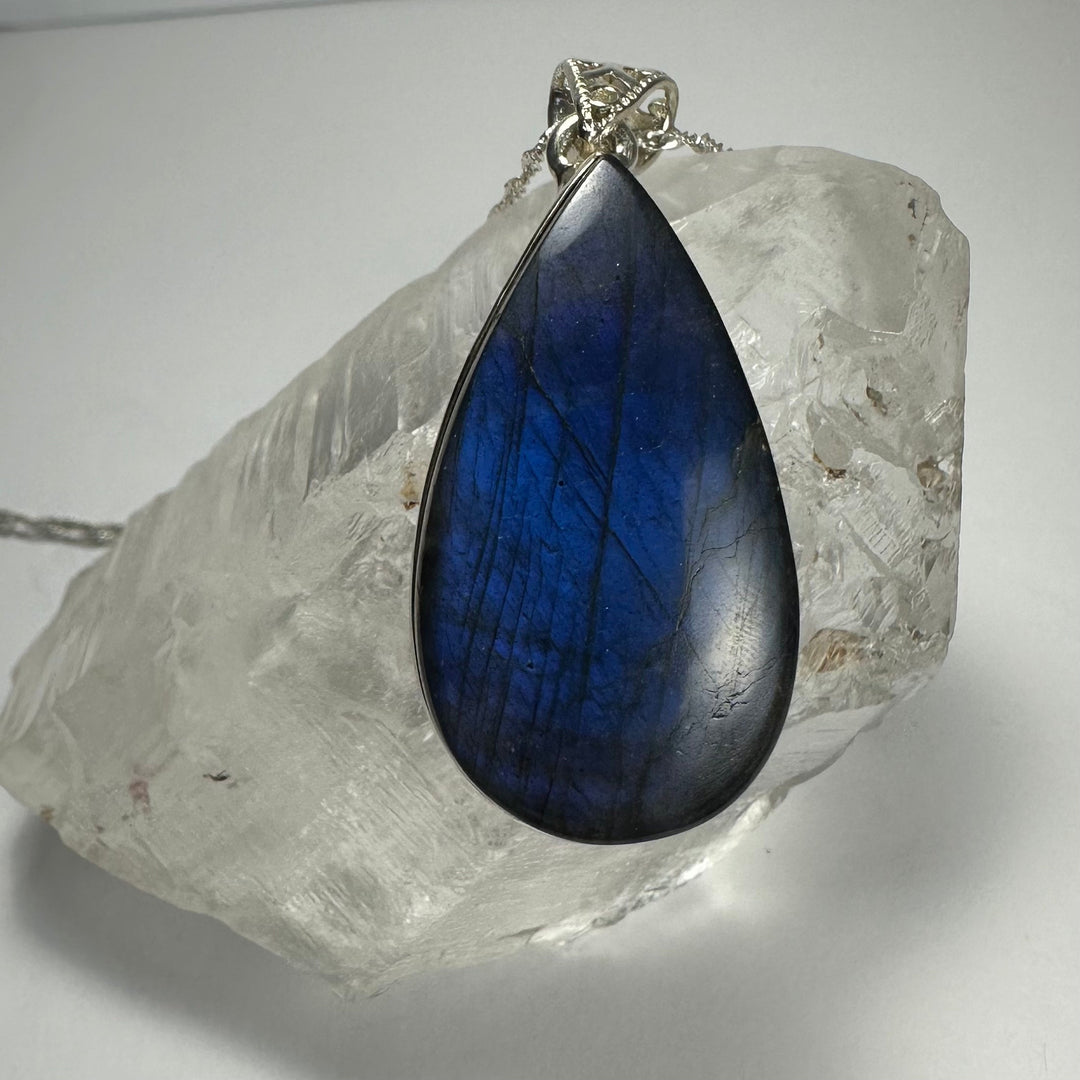 Deep blue labradorite teardrop pendant in silver-tone openwork bail