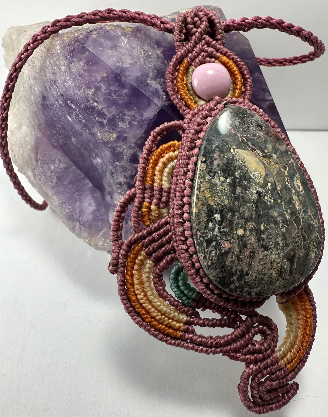 Handmade macrame necklace with burgundy cord, green teardrop stone and pink center bead