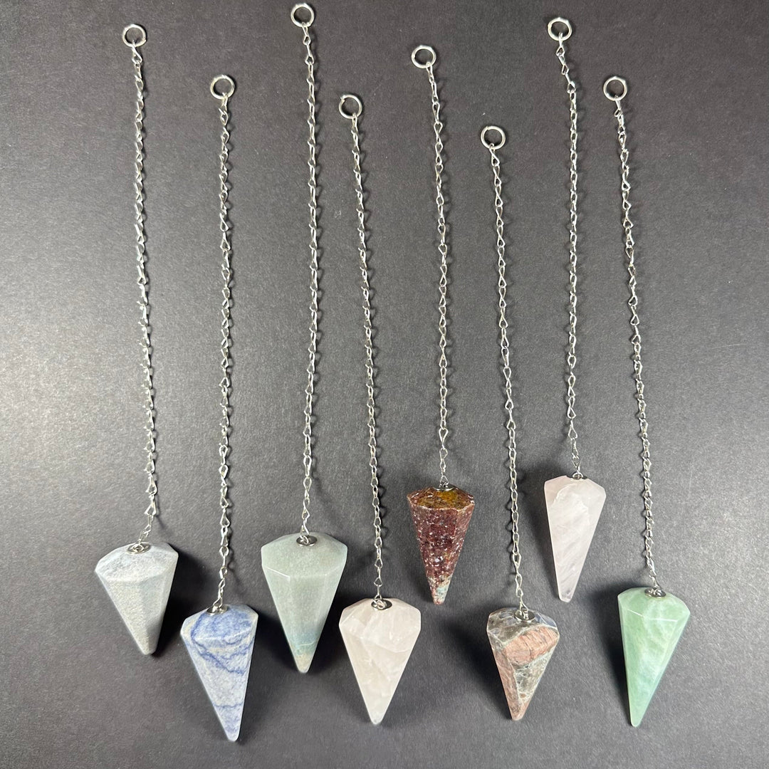 Stone pendulum necklace set with silver chains and faceted teardrop gemstones