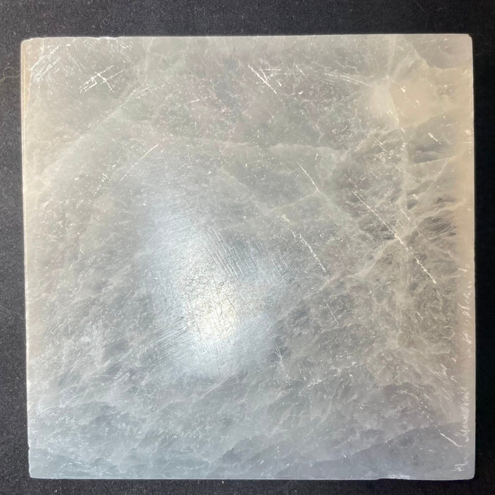 Square selenite crystal charging plate, translucent pale white with natural striations