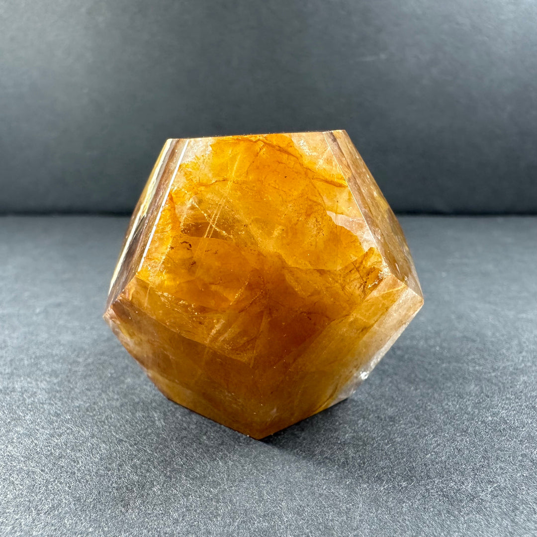 Yellow hematoid quartz dodecahedron with glossy clear face and warm golden color
