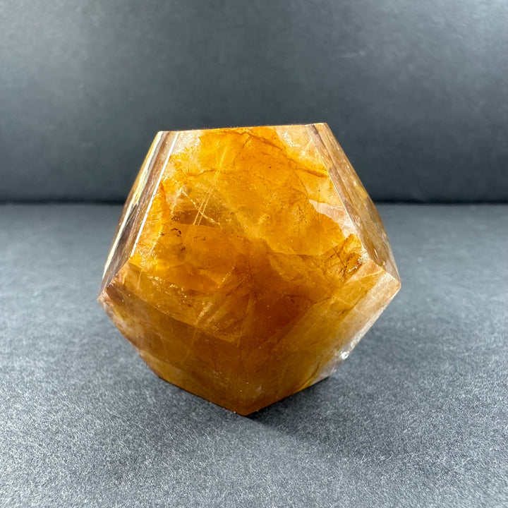 Yellow hematoid quartz dodecahedron with glossy clear face and warm golden color