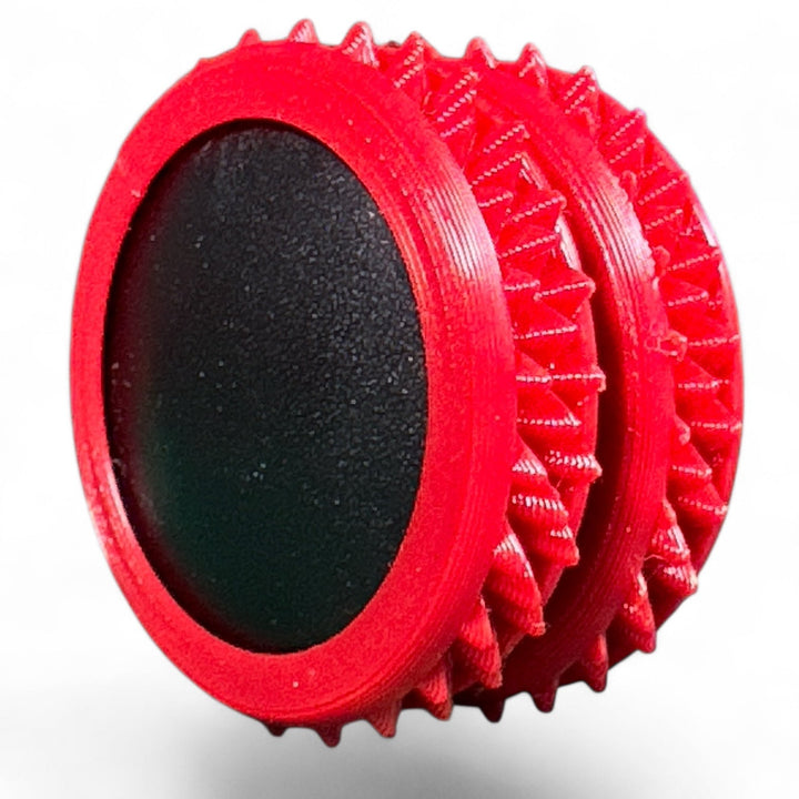 Red and black fidget gear pair with spiky edges and oval center pads