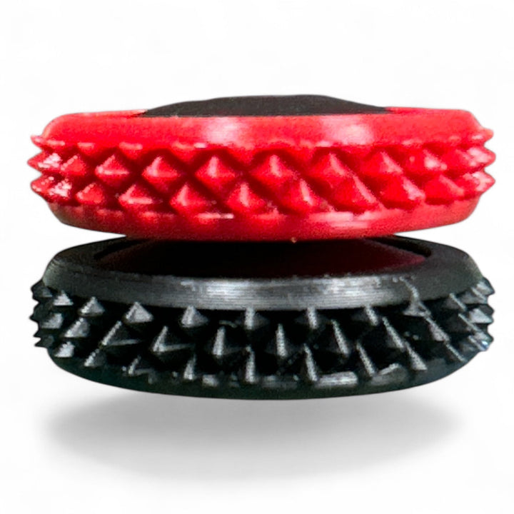 Red and black spiky fidget gear discs stacked, oval opening visible