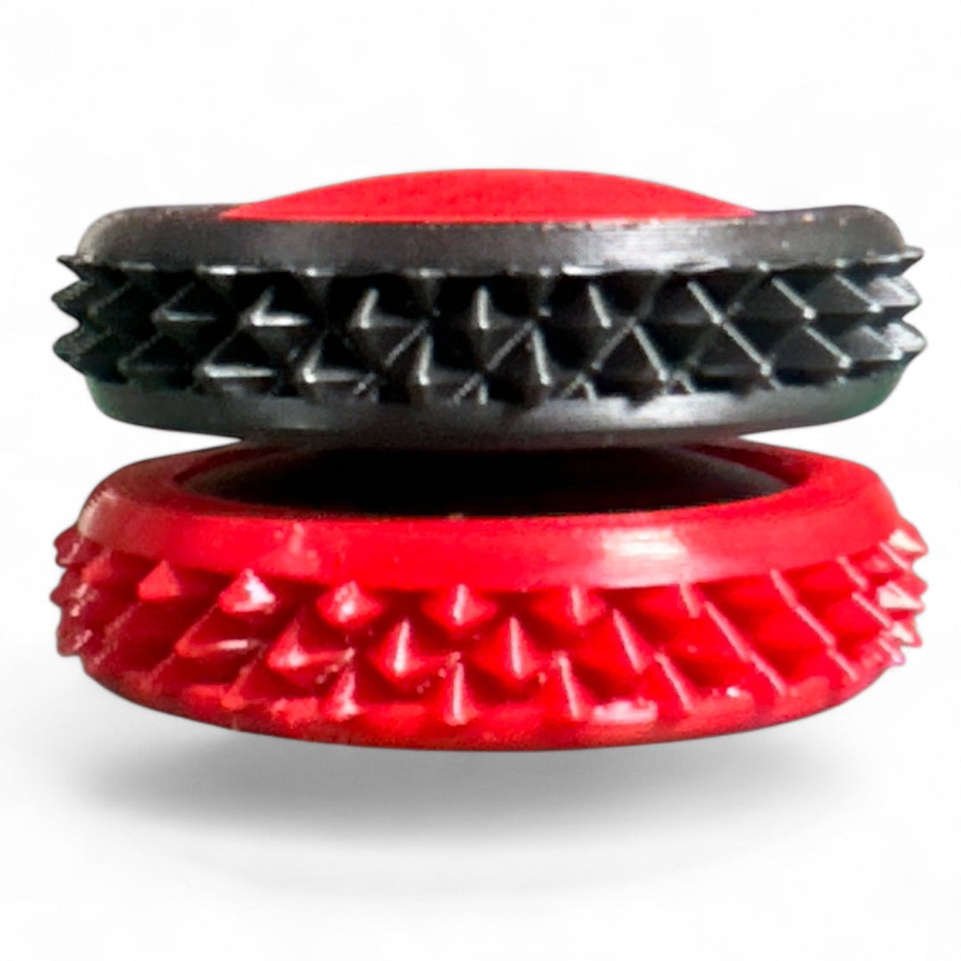 Black and red spiky fidget gear discs stacked, oval center openings