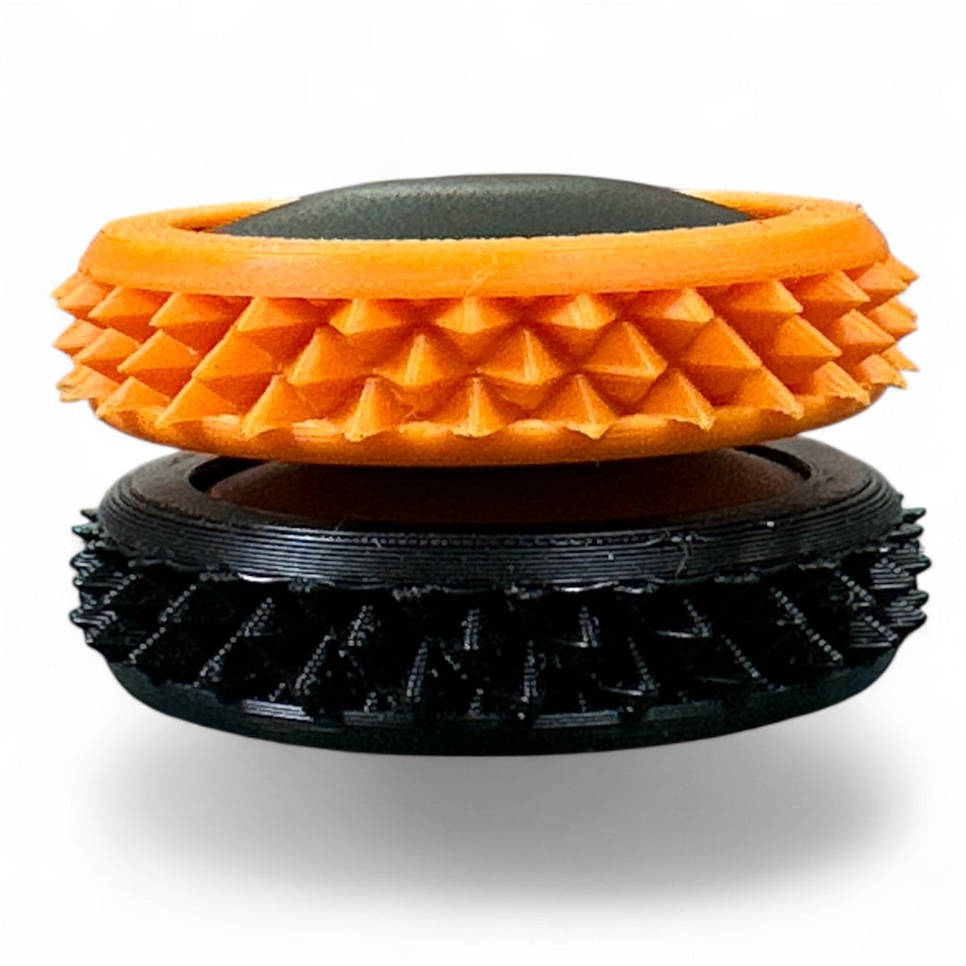 Orange and black spiky fidget gear discs with textured rings and oval center