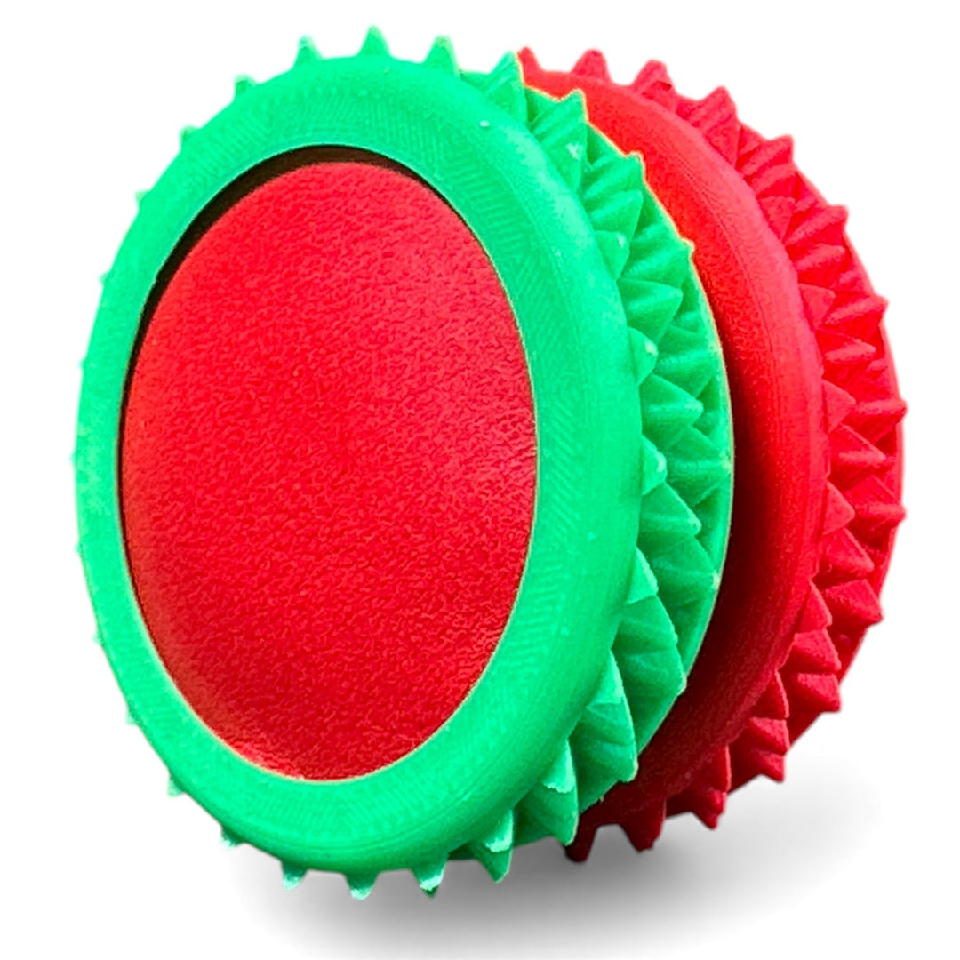 Green fidget moon toy with red oval center and spiky layered rings