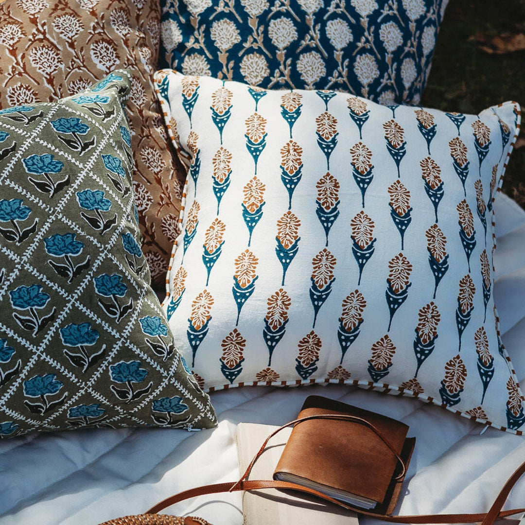 Throw pillow cover with navy, white, and orange vertical teardrop floral motif print