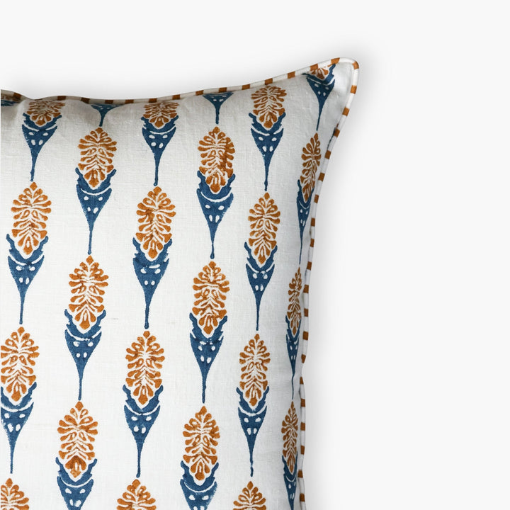 Throw pillow cover corner with white base and navy teardrop floral motifs