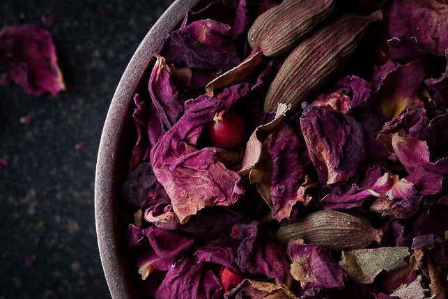 Tea tasting flight herbal blend in a gray bowl, purple petals and stems