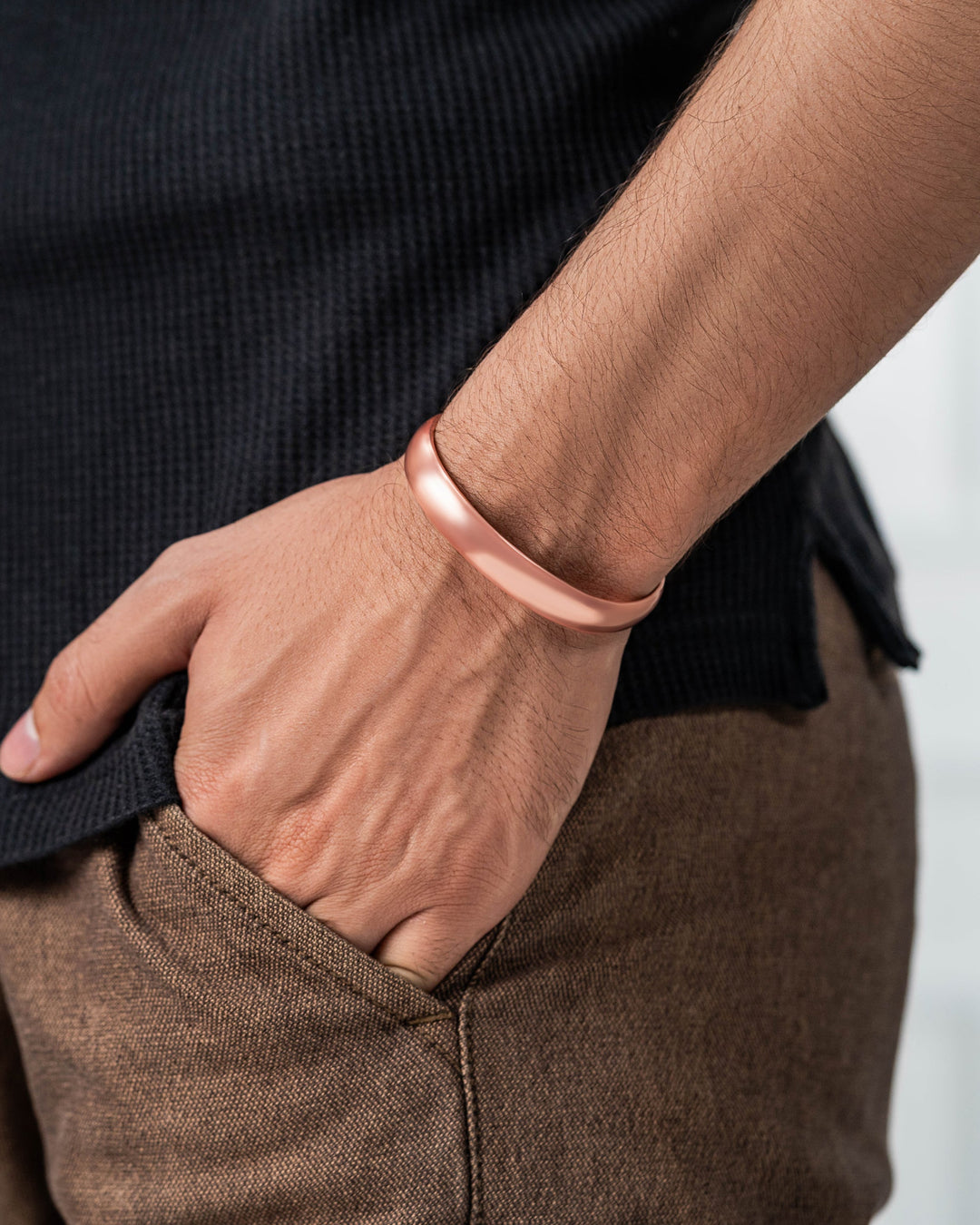 Copper cuff bracelet on wrist, smooth polished band close-up