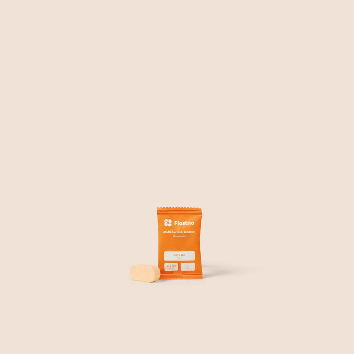 Multi cleaner tablet in orange package with a beige tablet
