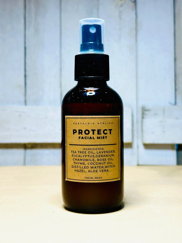 Protect facial mist bottle with blue spray, amber liquid and ingredient label