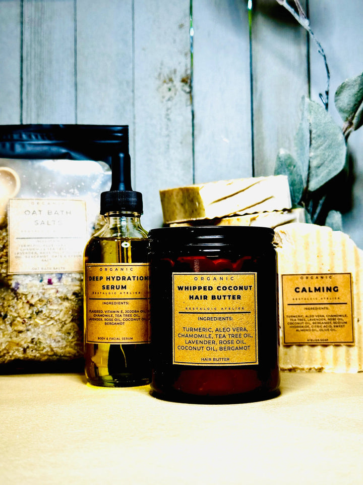 Calming skin kit with amber serum bottle and dark balm jars, plus labeled box