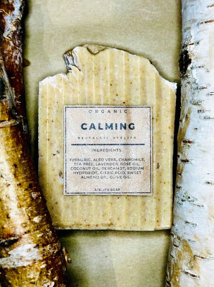 Organic calming bar soap with paper label, on textured wrap