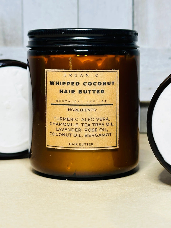 Organic whipped coconut hair butter jar with black lid, labeled ingredients