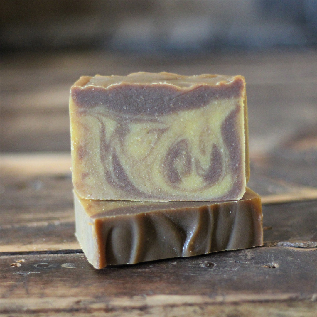Chocolate soap bar with pumpkin swirl, cut showing purple and green layers
