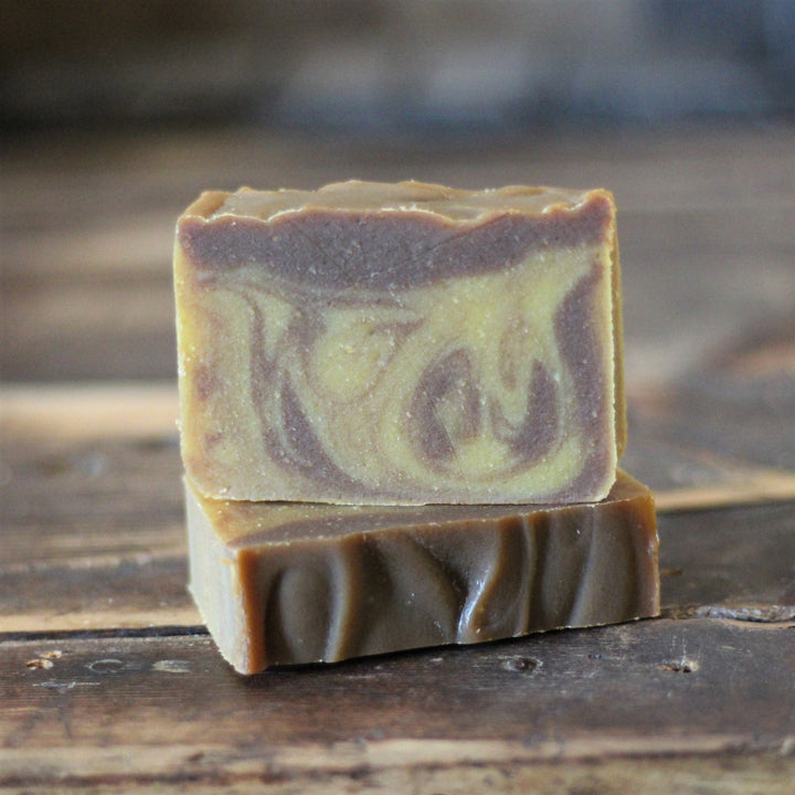 Chocolate soap bar with pumpkin swirl, cut showing purple and green layers