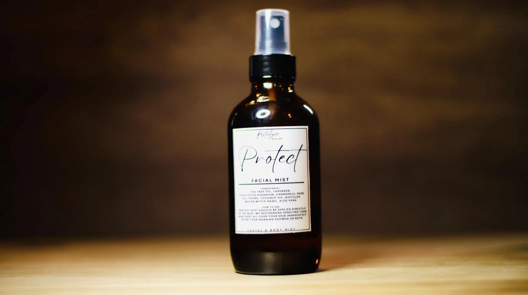 Facial mist spray bottle with silver pump, dark amber liquid, "Protect" label