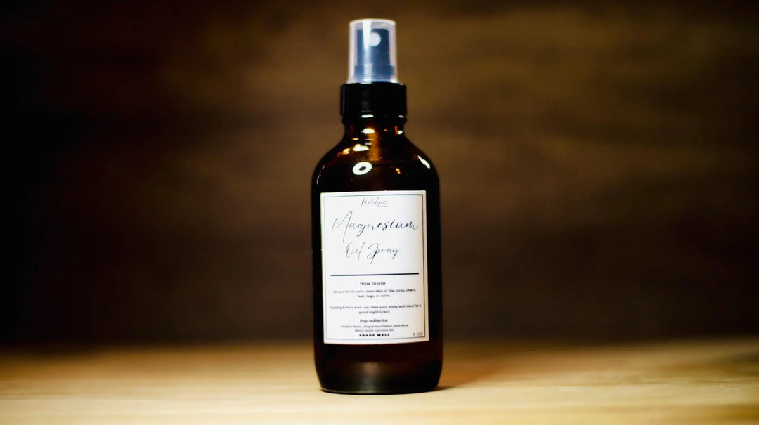 Facial mist spray bottle with silver pump, dark amber liquid, "Magnesium" label