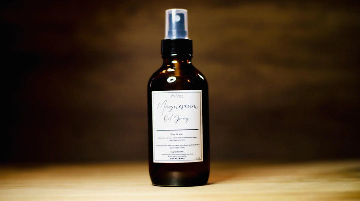 Facial mist spray bottle with silver pump, dark amber liquid, "Magnesium" label