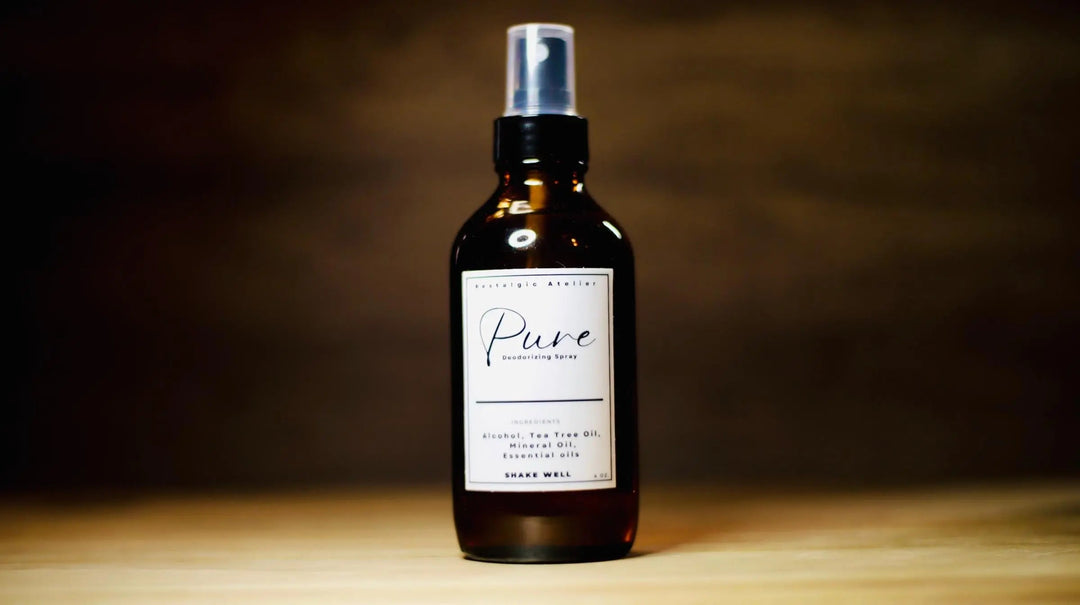 Facial mist spray bottle with silver pump, dark amber liquid, "Pure" label