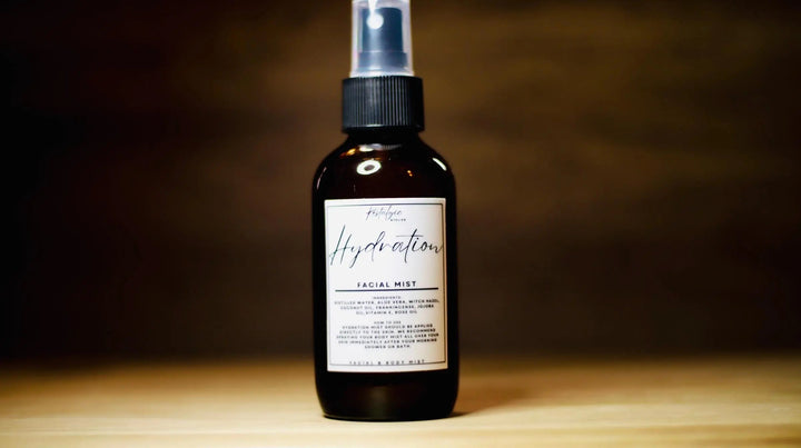 Hydration facial mist spray bottle with silver pump, dark amber liquid, white label