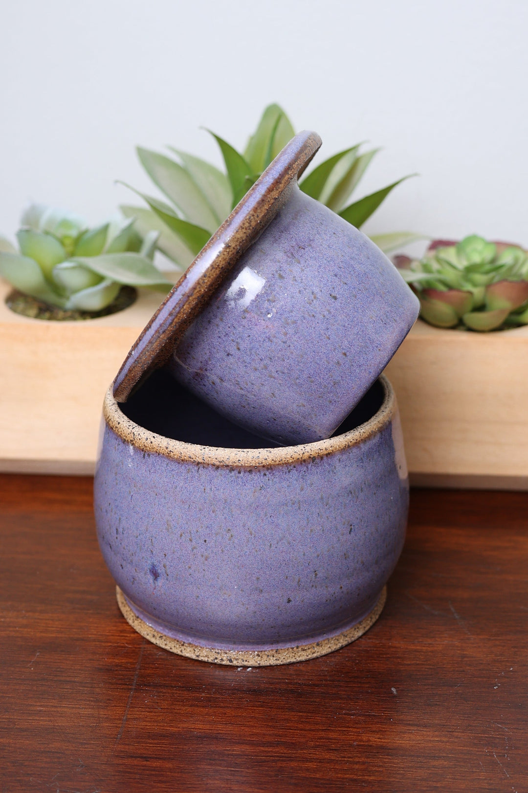 Ceramic butter dish set with lavender speckled cups on round base, hinged-style piece