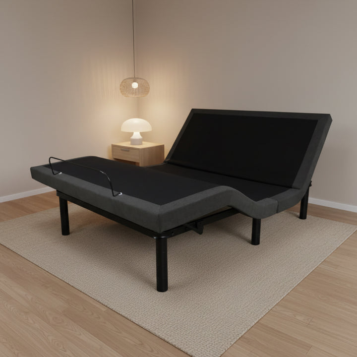 Queen adjustable bed frame base with dark upholstery, raised head section on legs