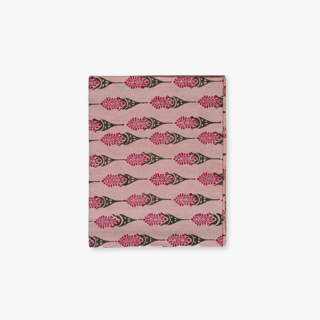 Bahaar hand-printed table runner in pink with repeating floral leaf motifs