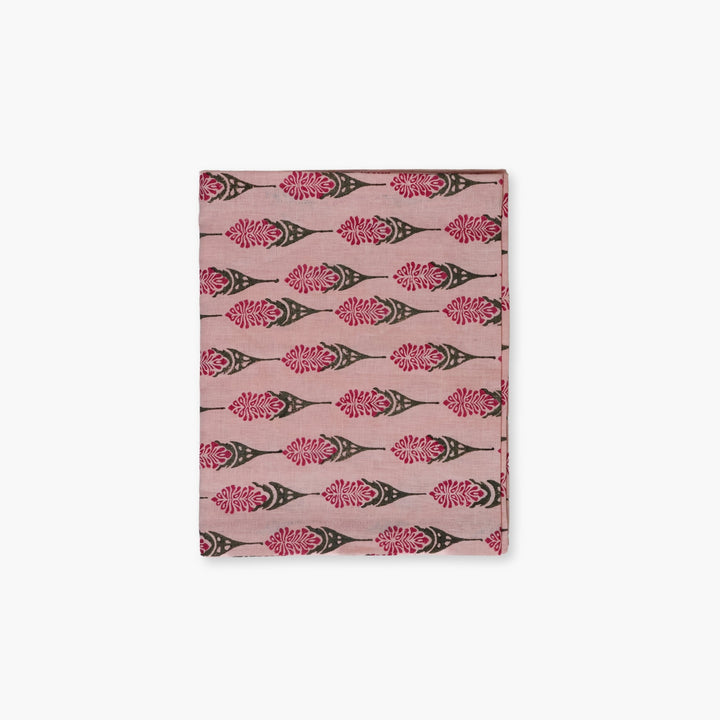 Bahaar hand-printed table runner in pink with repeating floral leaf motifs