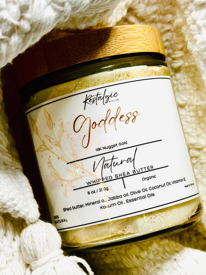 Shimmer body butter jar close-up on white knit background, gold cap and label visible