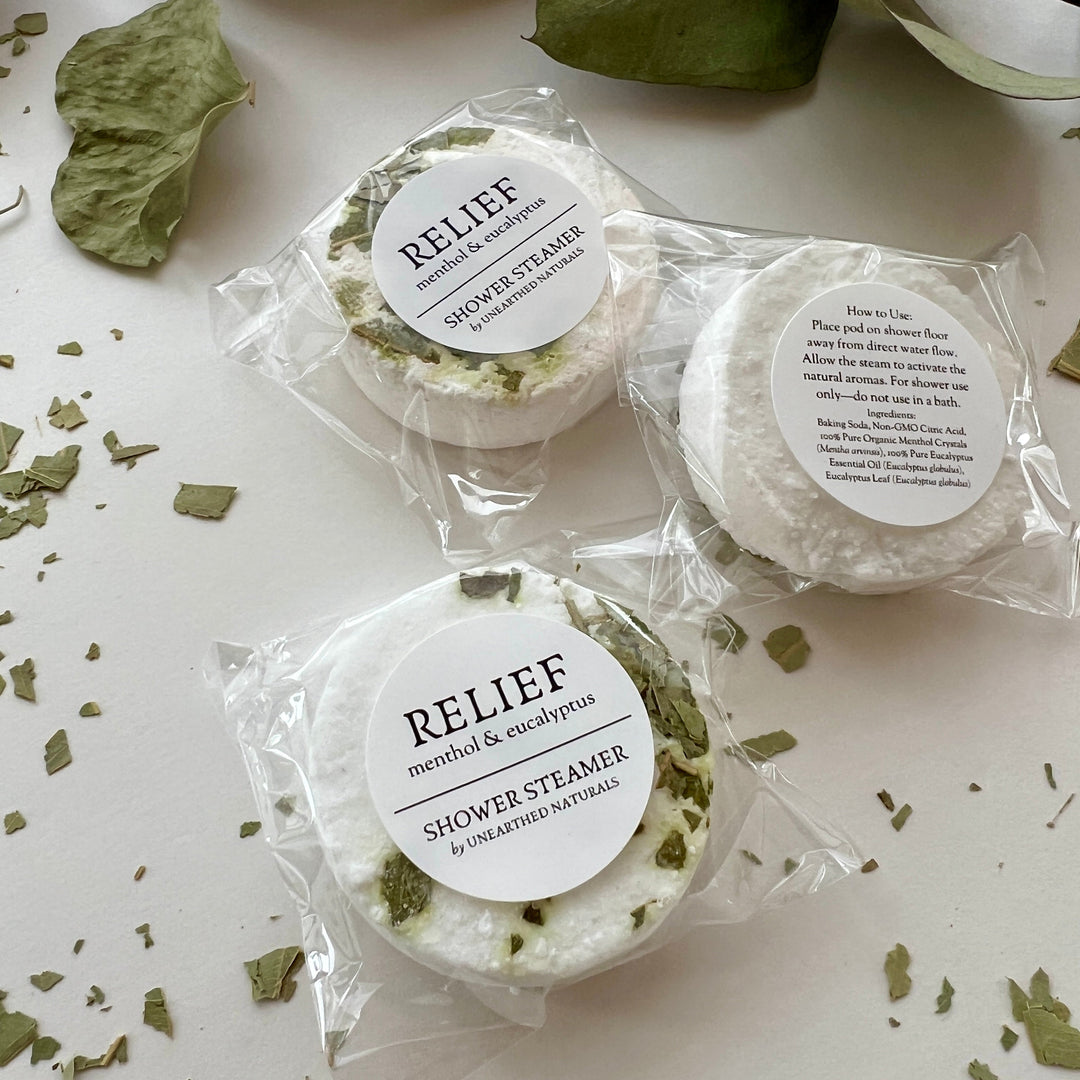 Menthol &amp; eucalyptus shower steamer discs in clear plastic wrap, round with green speckles