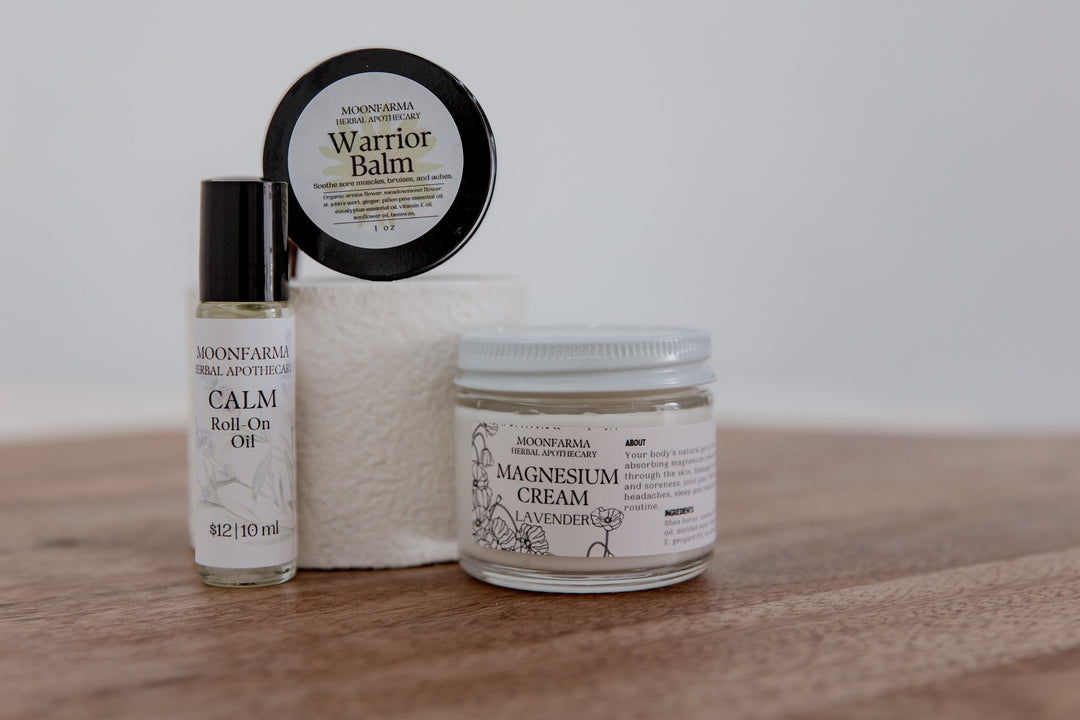 Skincare recovery set: balm tin, roll-on oil, and magnesium cream jar.