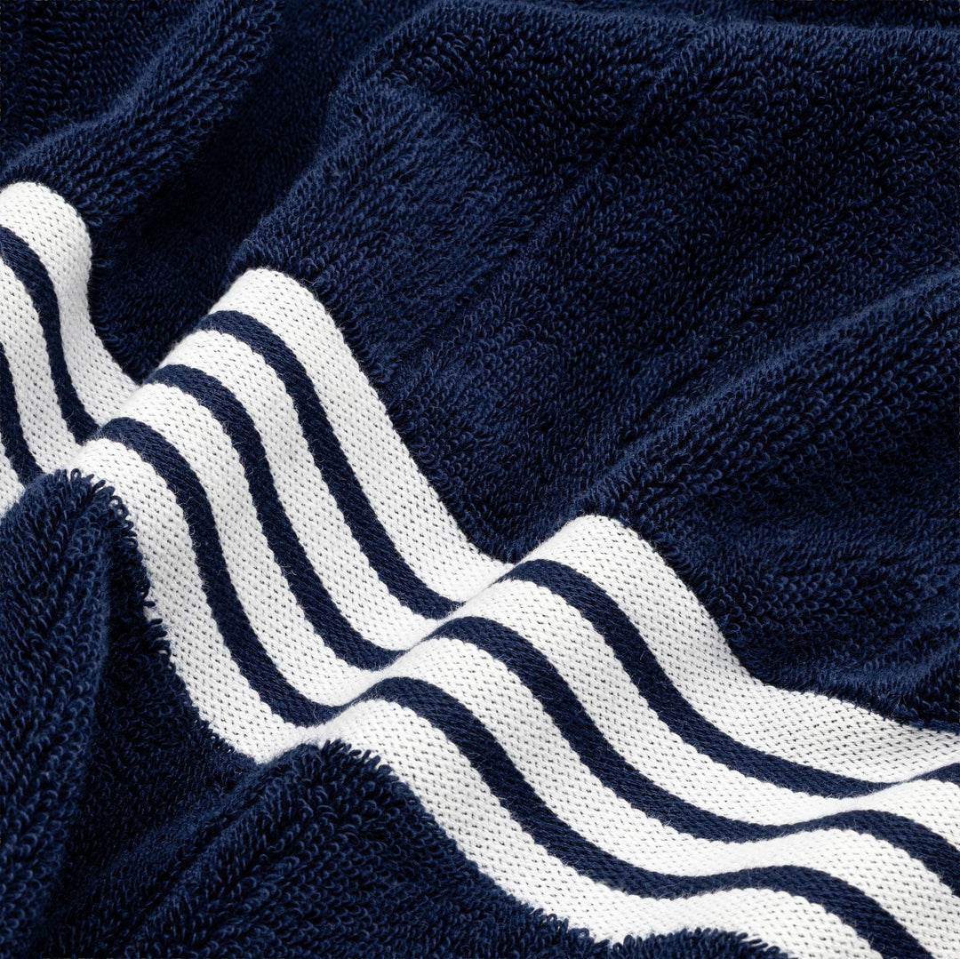 Navy cotton towel fabric with raised texture and bold white striped border