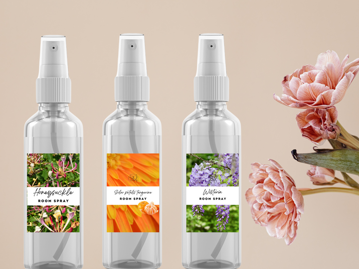Set of three room spray bottles with white pump sprayers and floral scent labels