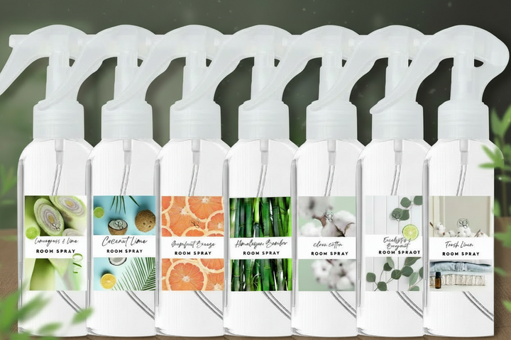 Row of room and linen spray bottles with white trigger nozzles.