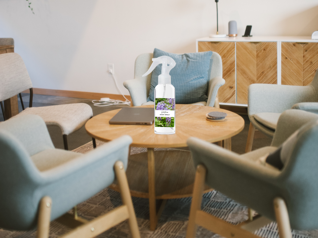 Room and linen spray bottle with white trigger nozzle, standing on a tabletop